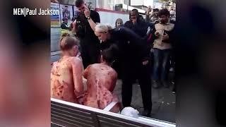 Naked women covered in JAM stun Manchester city centre shoppers by sitting on bench in broad